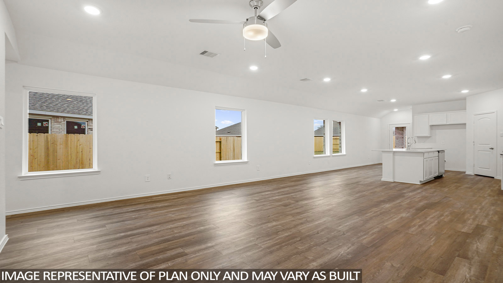 open concept living and dining area with vinyl flooring, large windows, and quartz countertops in Katy, TX