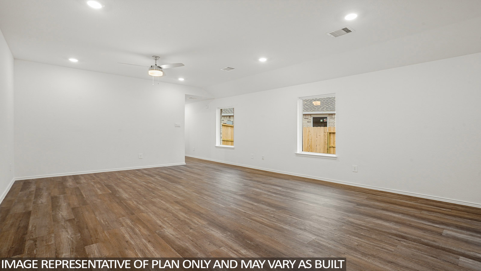 open concept living and dining area with vinyl flooring, large windows, and quartz countertops in Katy, TX