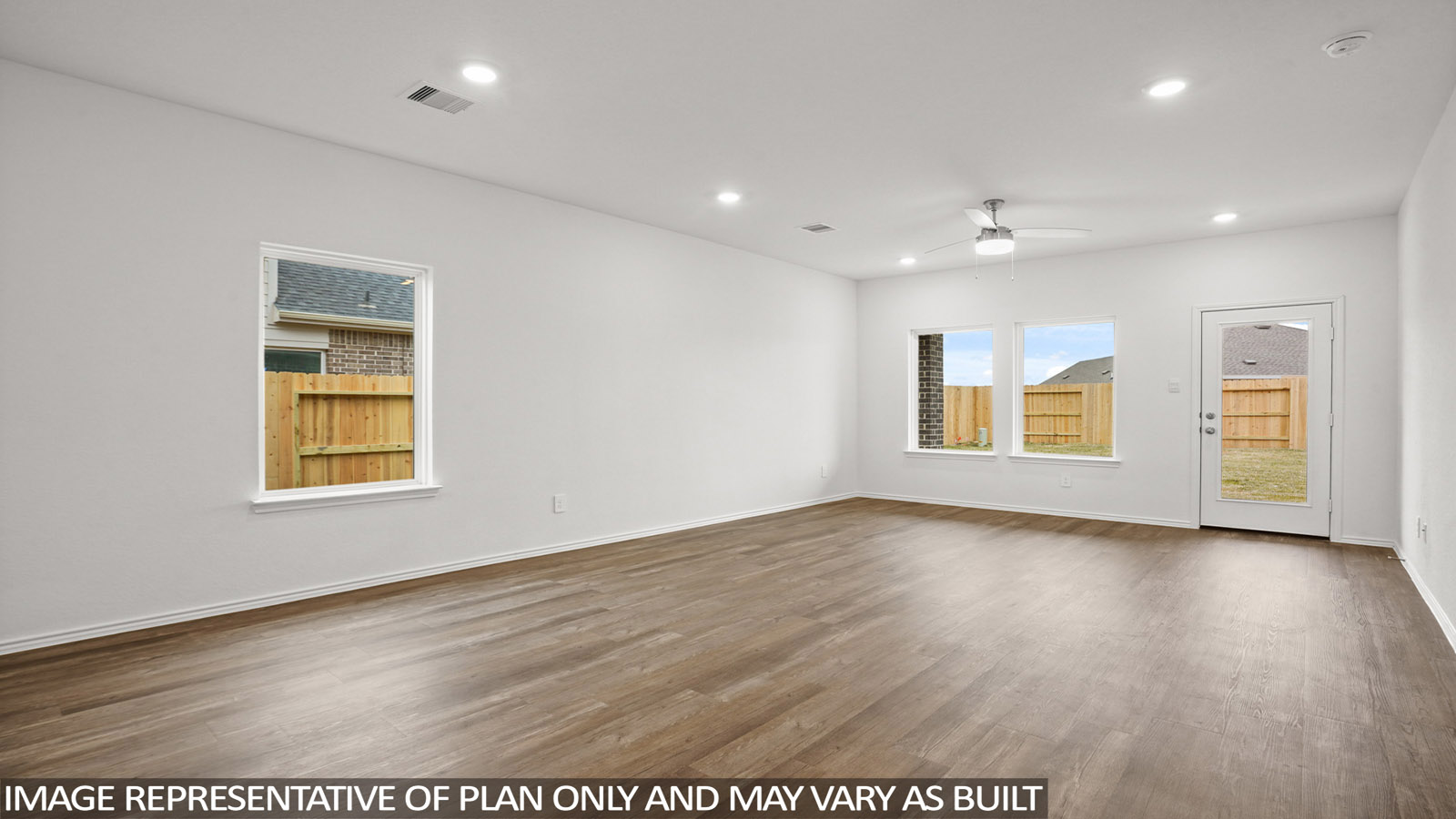 open concept livivng and dining area with vinyl flooring, quartz countertops, and large windows