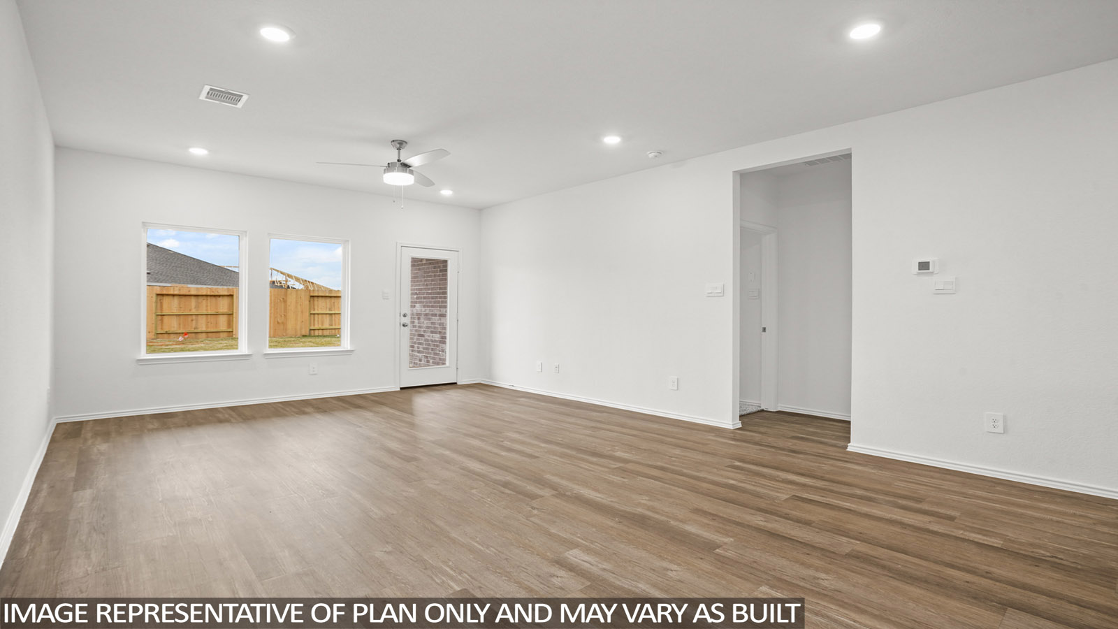 open concept living and dining area with vinyl flooring, large windows, and quartz countertops