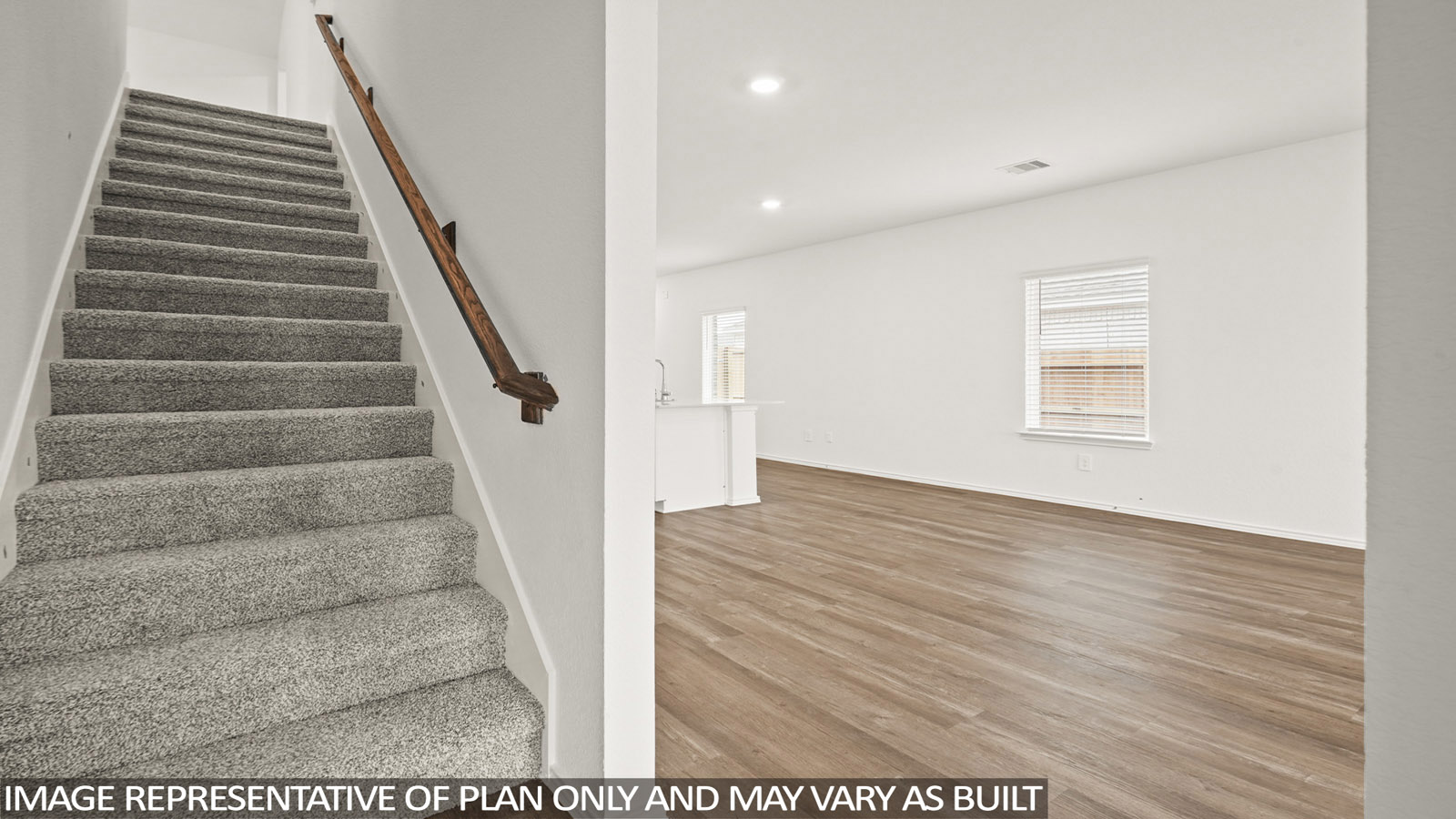 Spacious living area with vinyl flooring
