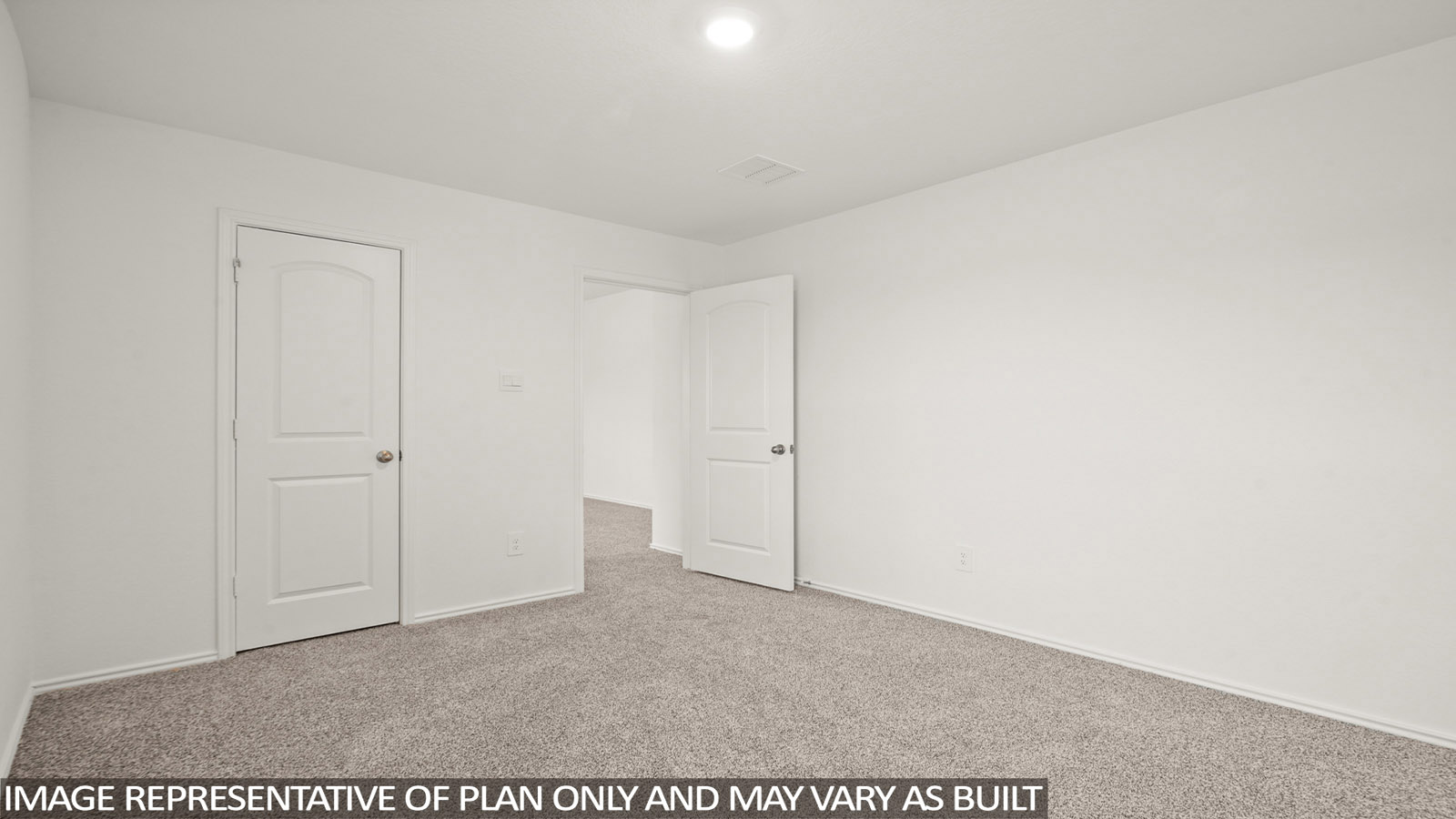 Secondary bedroom with carpet flooring