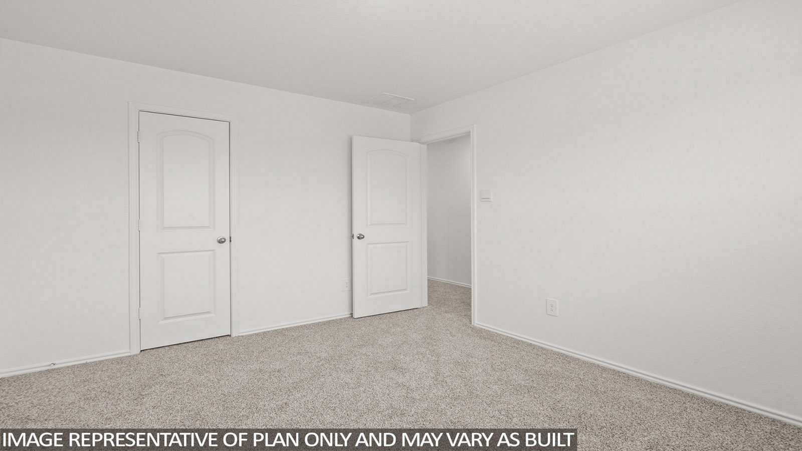 Secondary bedroom with carpet flooring