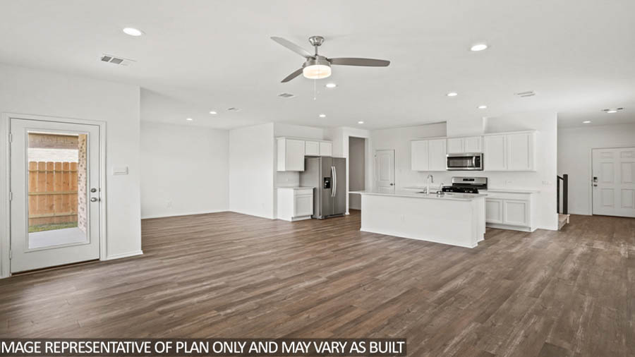 open concept livving and dining area with vinyl flooring, large windows, and quartz countertops in Katy, TX