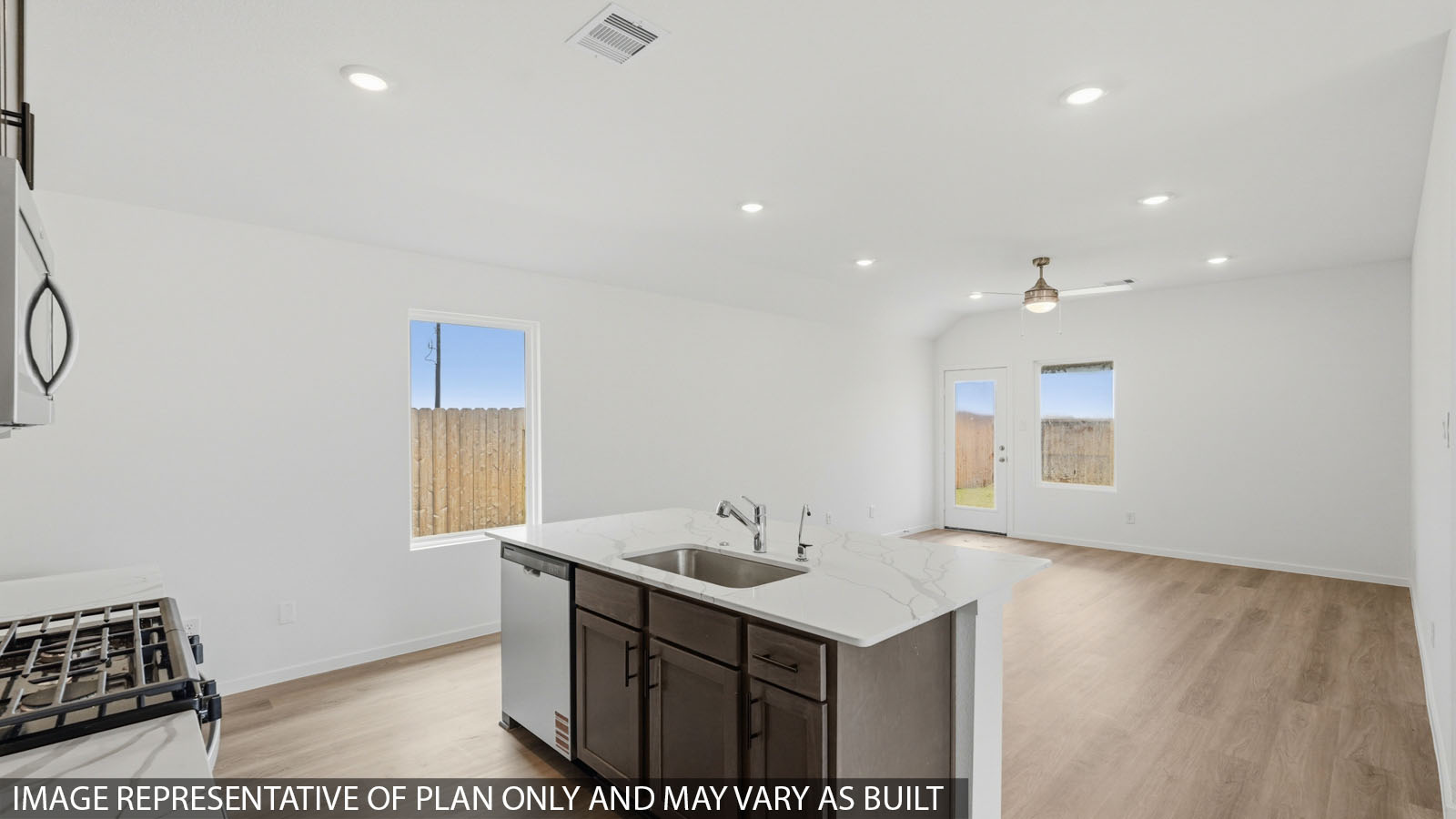 open concept living and dining area with vinyl flooring with quartz countertops