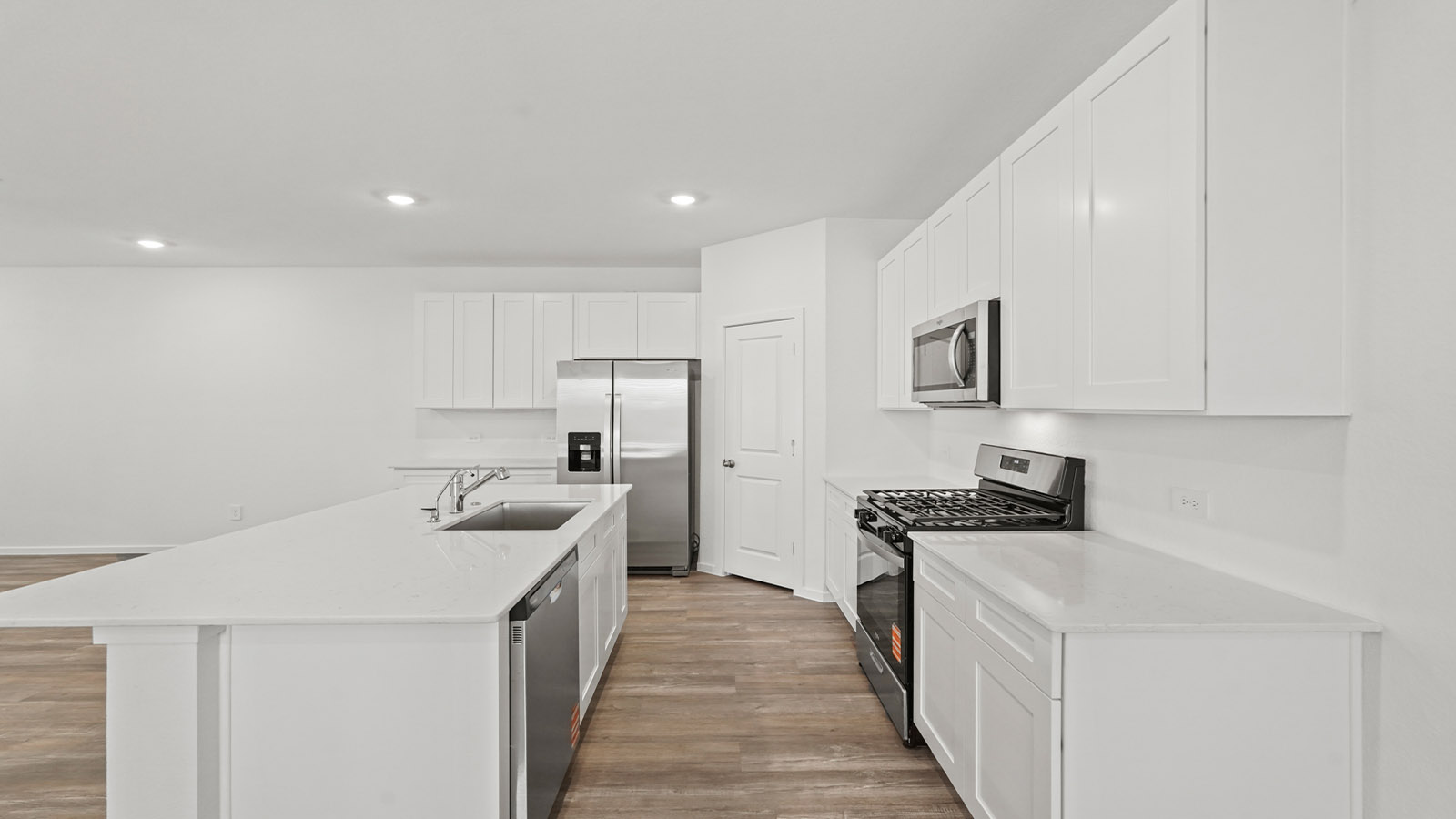 open concept living and dining area with vinyl flooring, quartz countertops, and large windows
