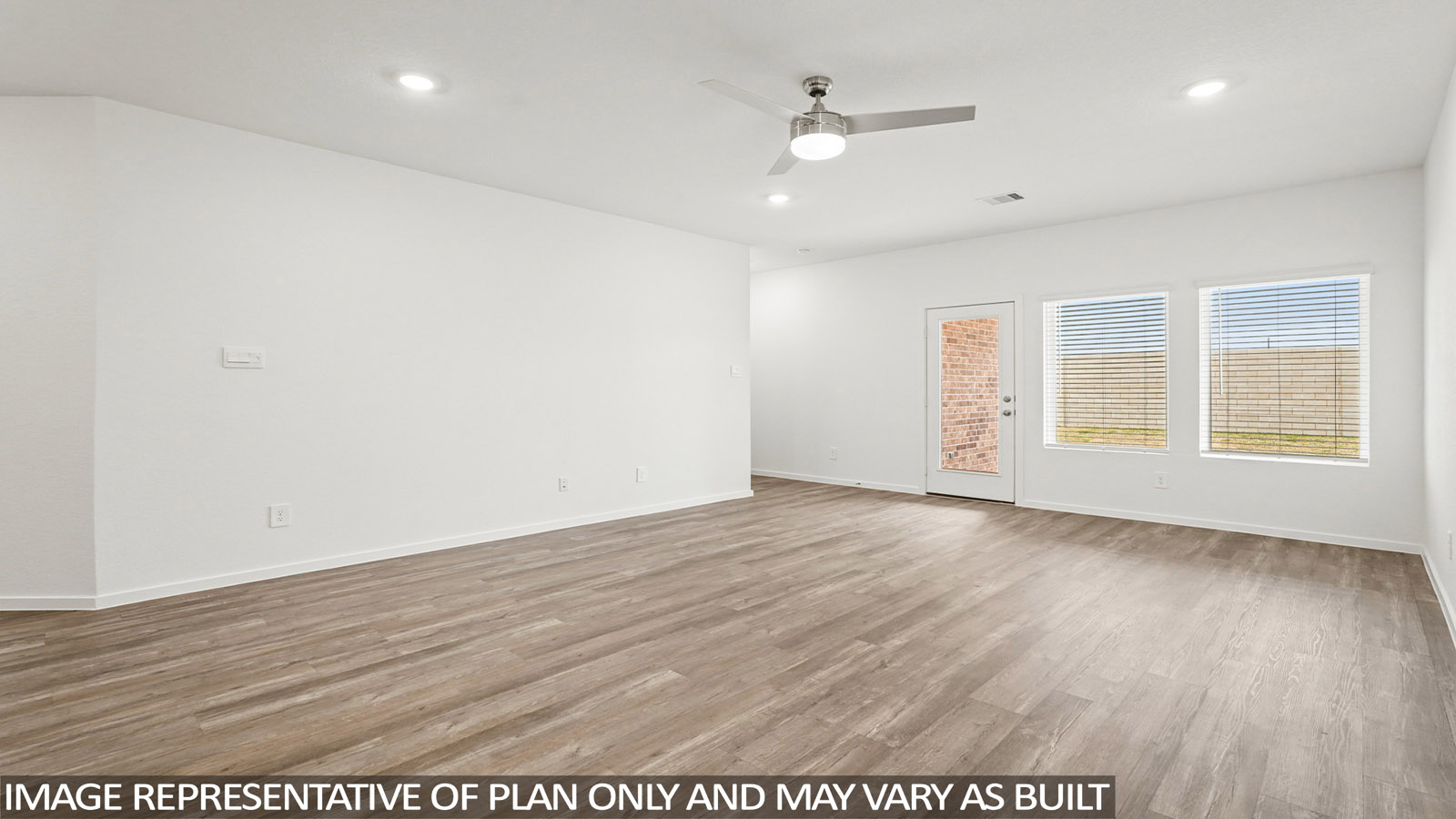 Spacious living area with vinyl flooring