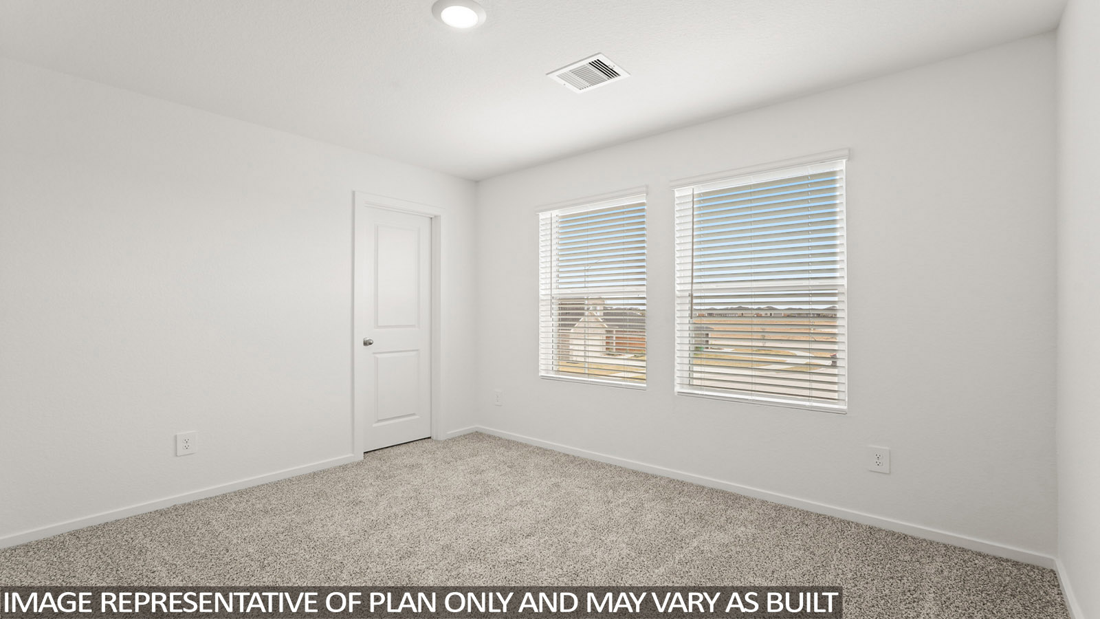 Secondary bedroom with carpet flooring