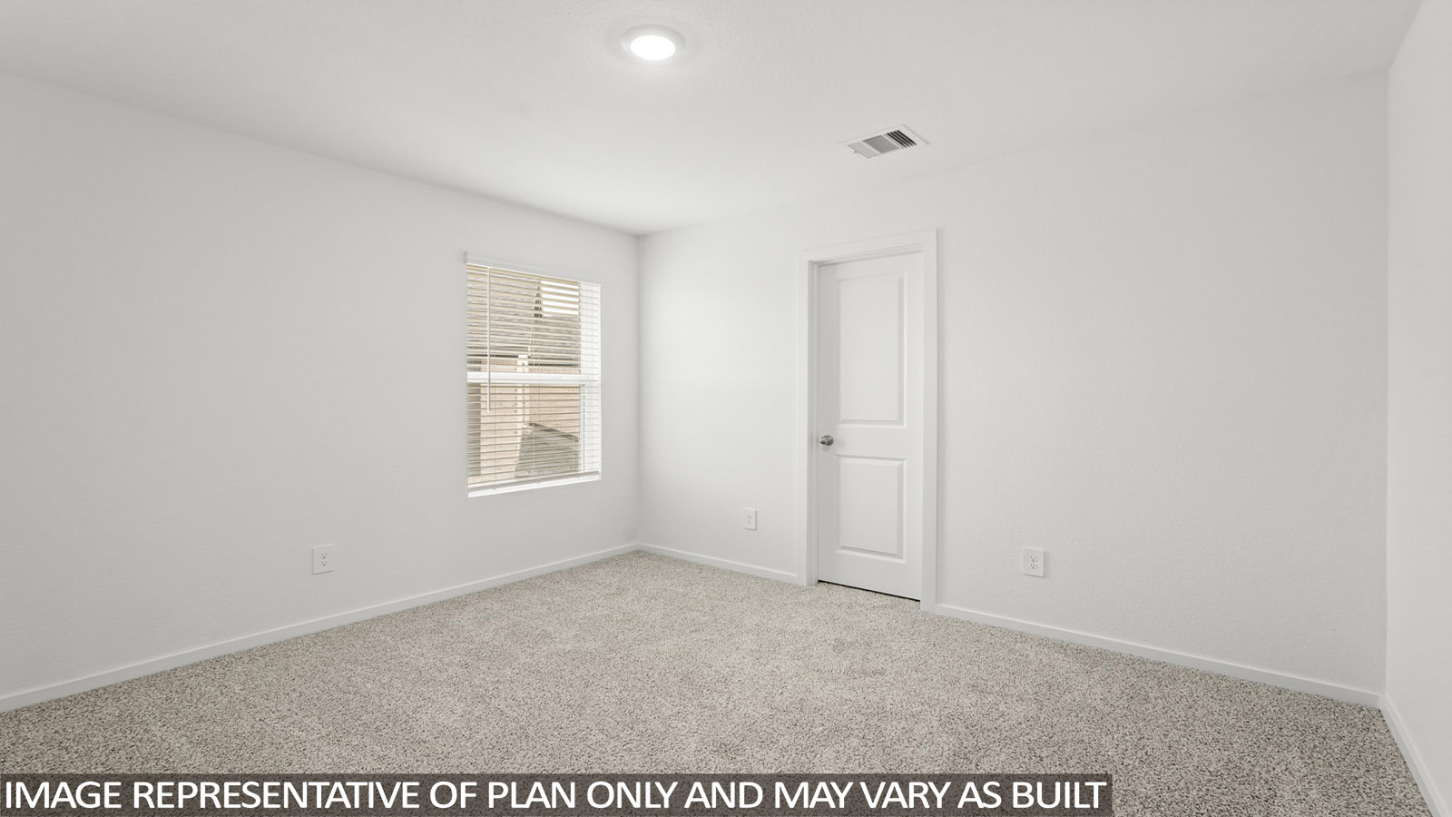 Secondary bedroom with carpet flooring