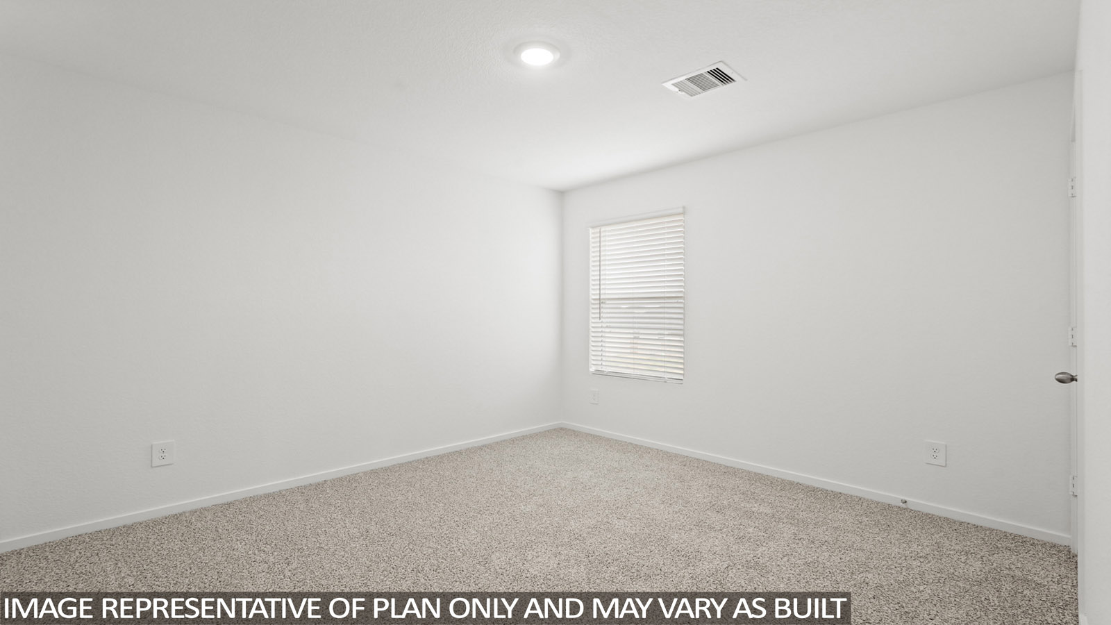 Secondary bedroom with carpet flooring