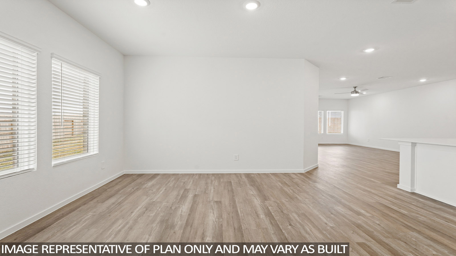 Spacious living area with vinyl flooring