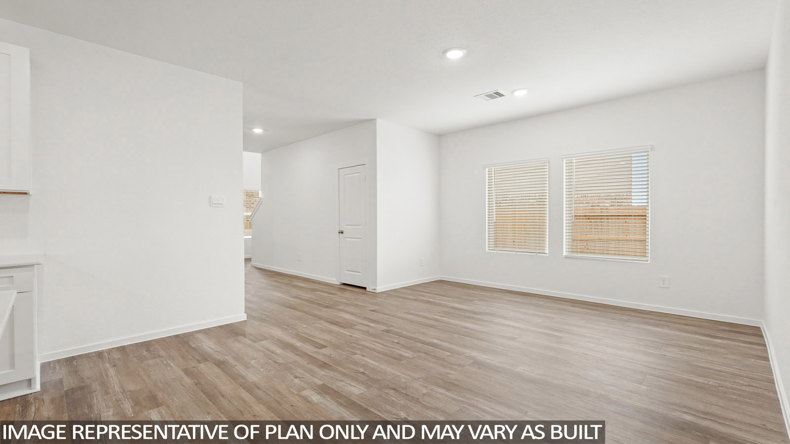 Spacious living area with vinyl flooring