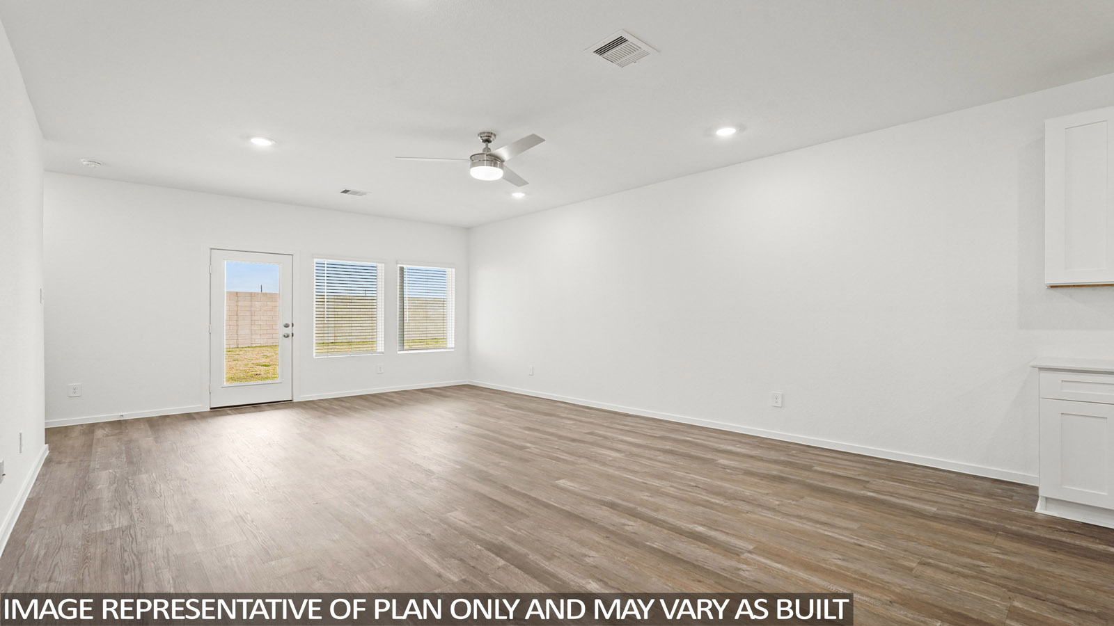 Spacious living area with vinyl flooring