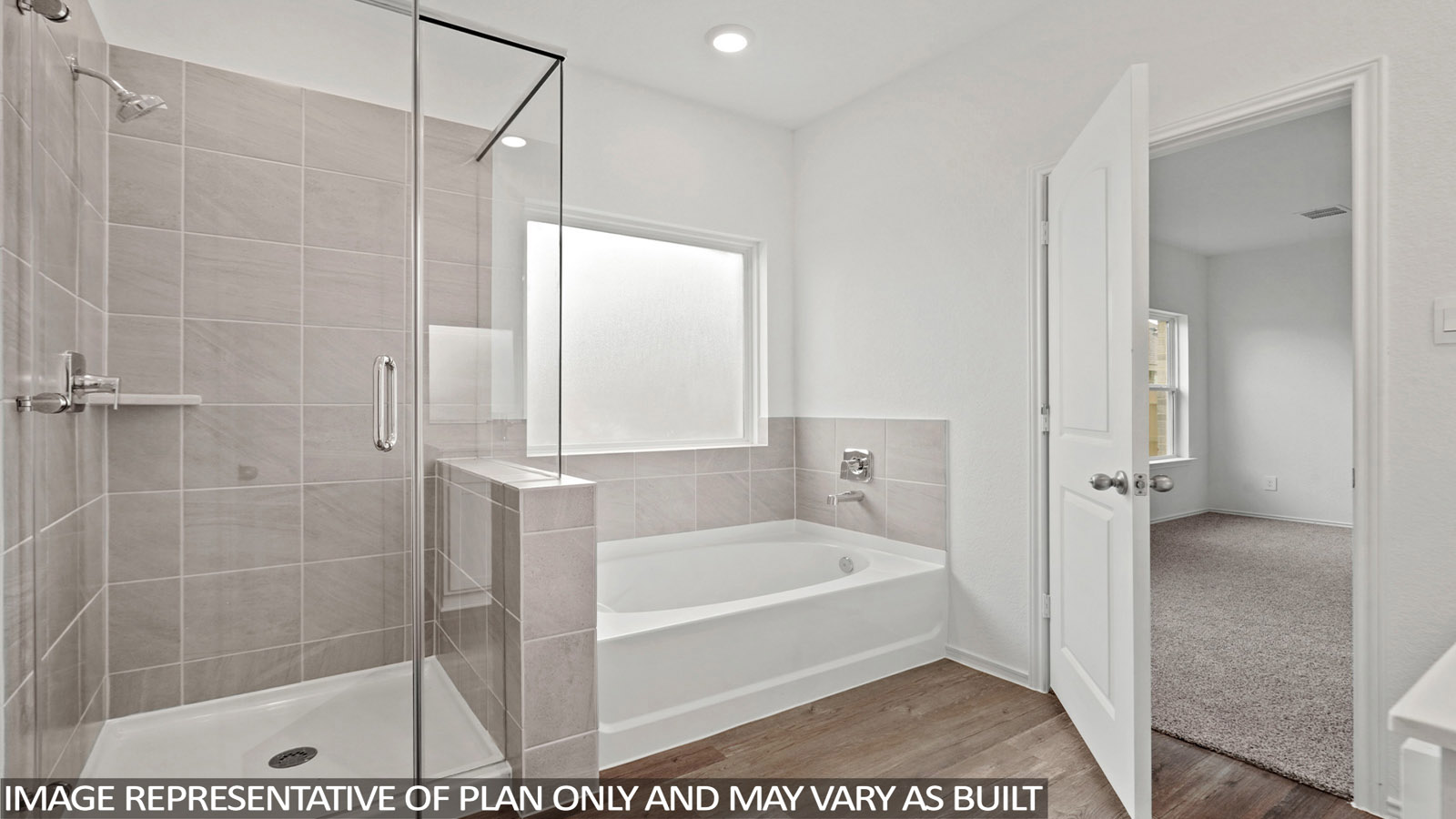 primary bathroom with separate tub and shower