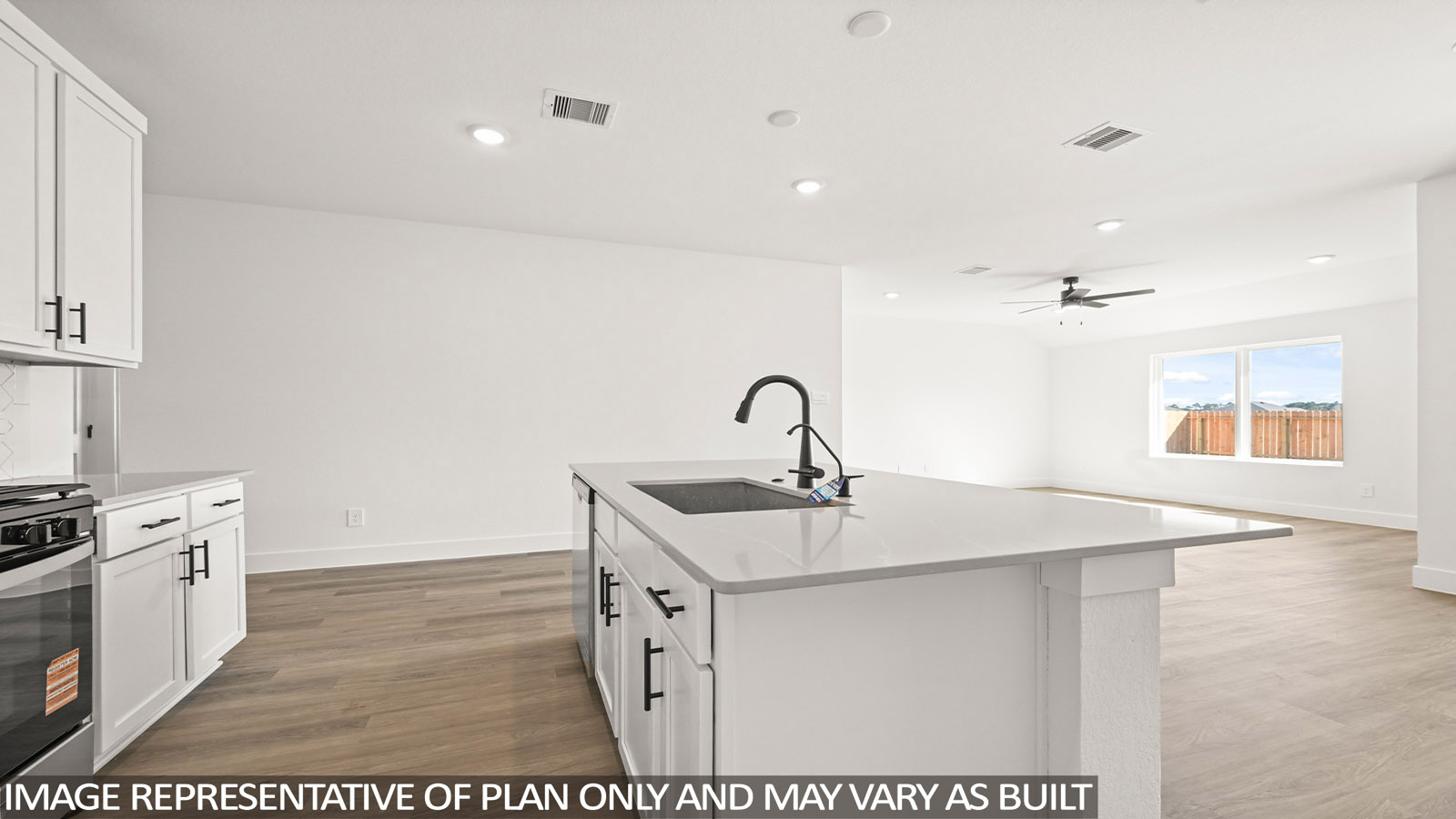 open concept living and dining area with vinyl flooring, quartz countertops, and stainless steel appliances in Katy,Tx