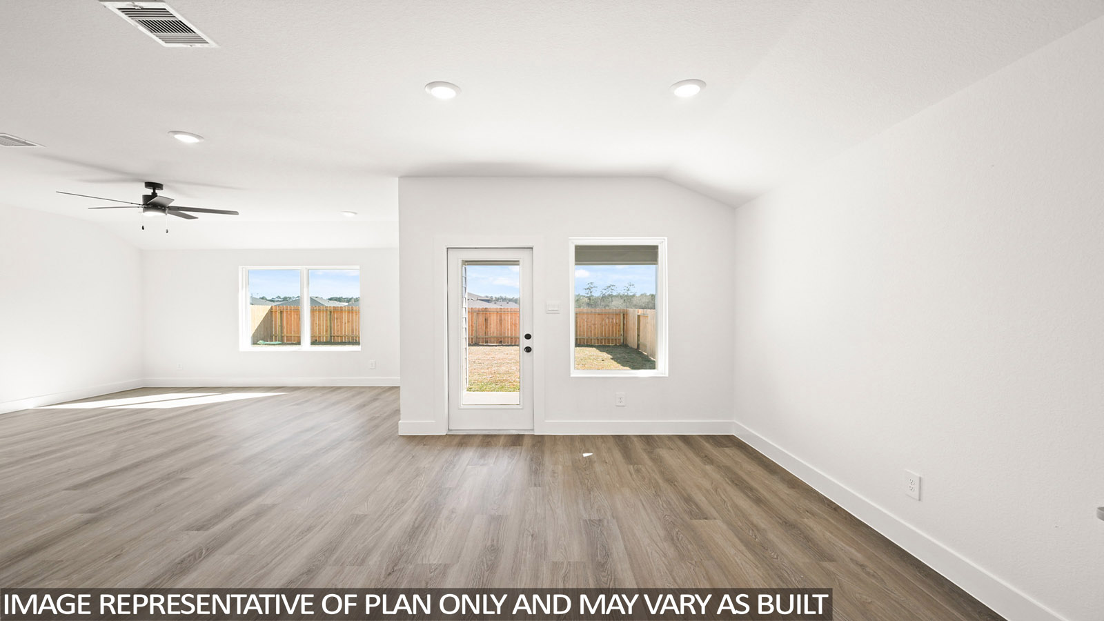open concept living and dining area with vinyl flooring, quartz countertops, and stainless steel appliances in Katy,Tx