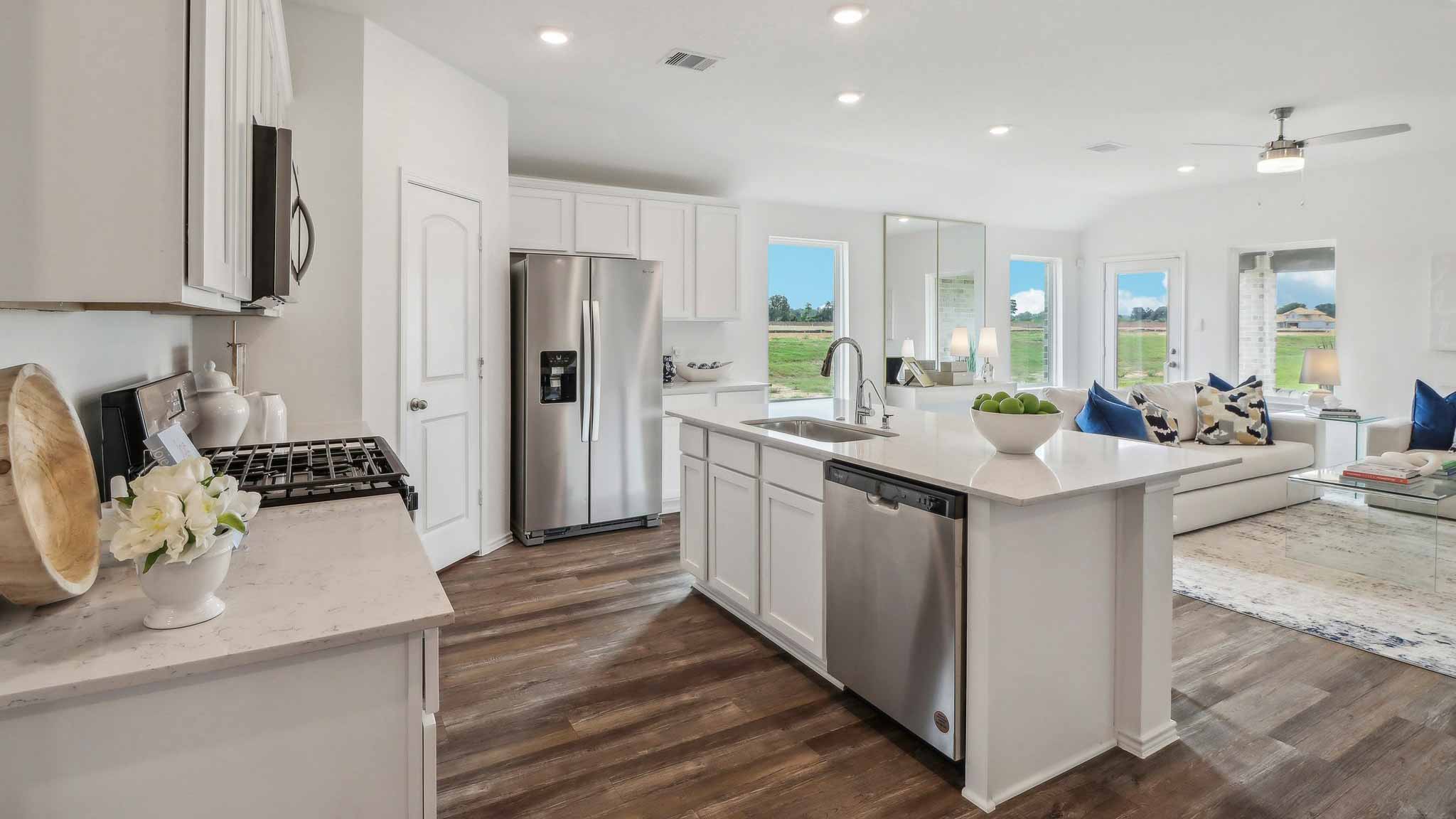open concept living and dining area with vinyl flooring, large windows, and quartz countertops