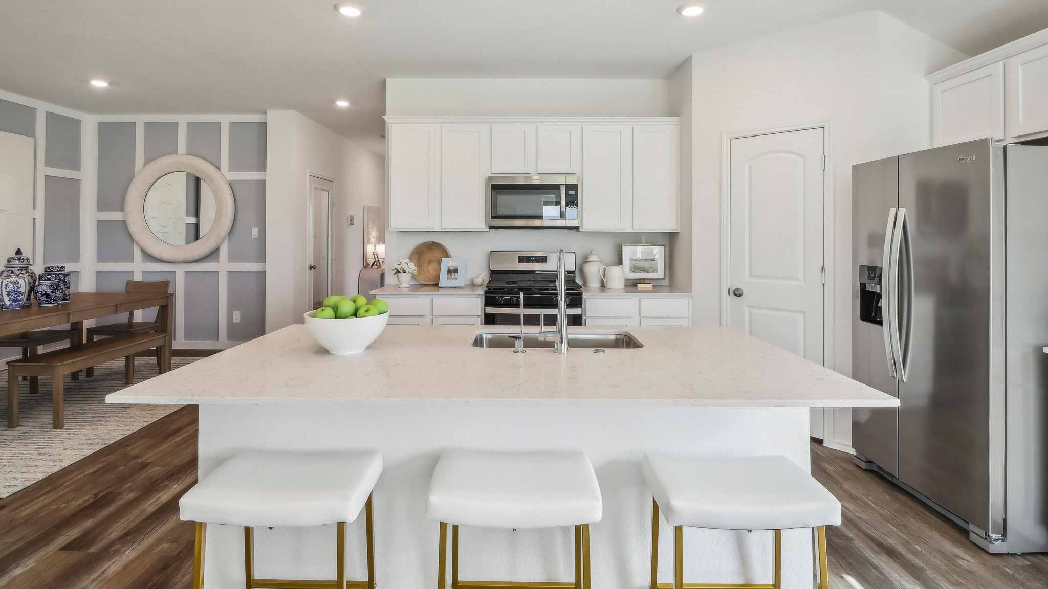 open concept living and dining area with vinyl flooring, large windows, and quartz countertops