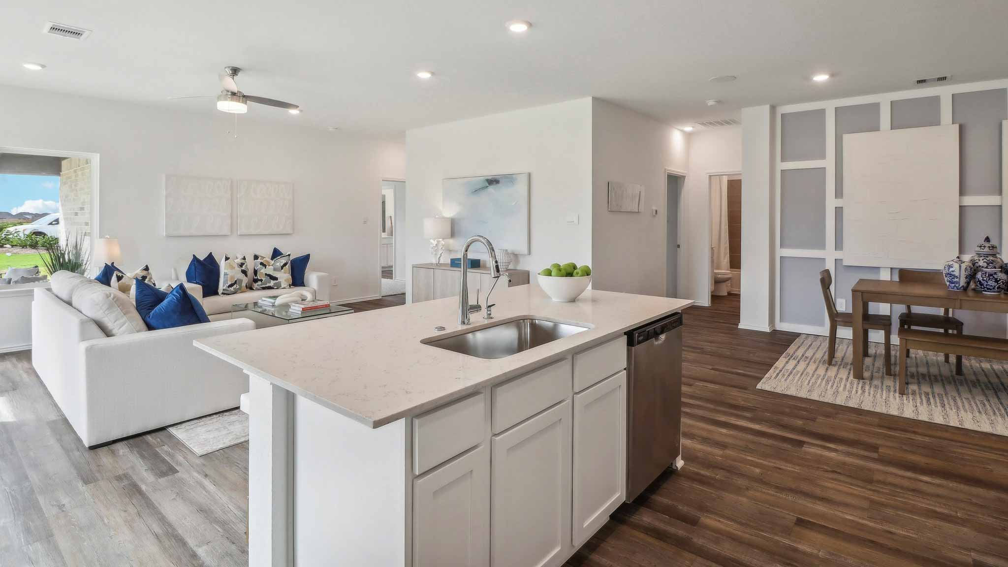 open concept living and dining area with vinyl flooring, large windows, and quartz countertops