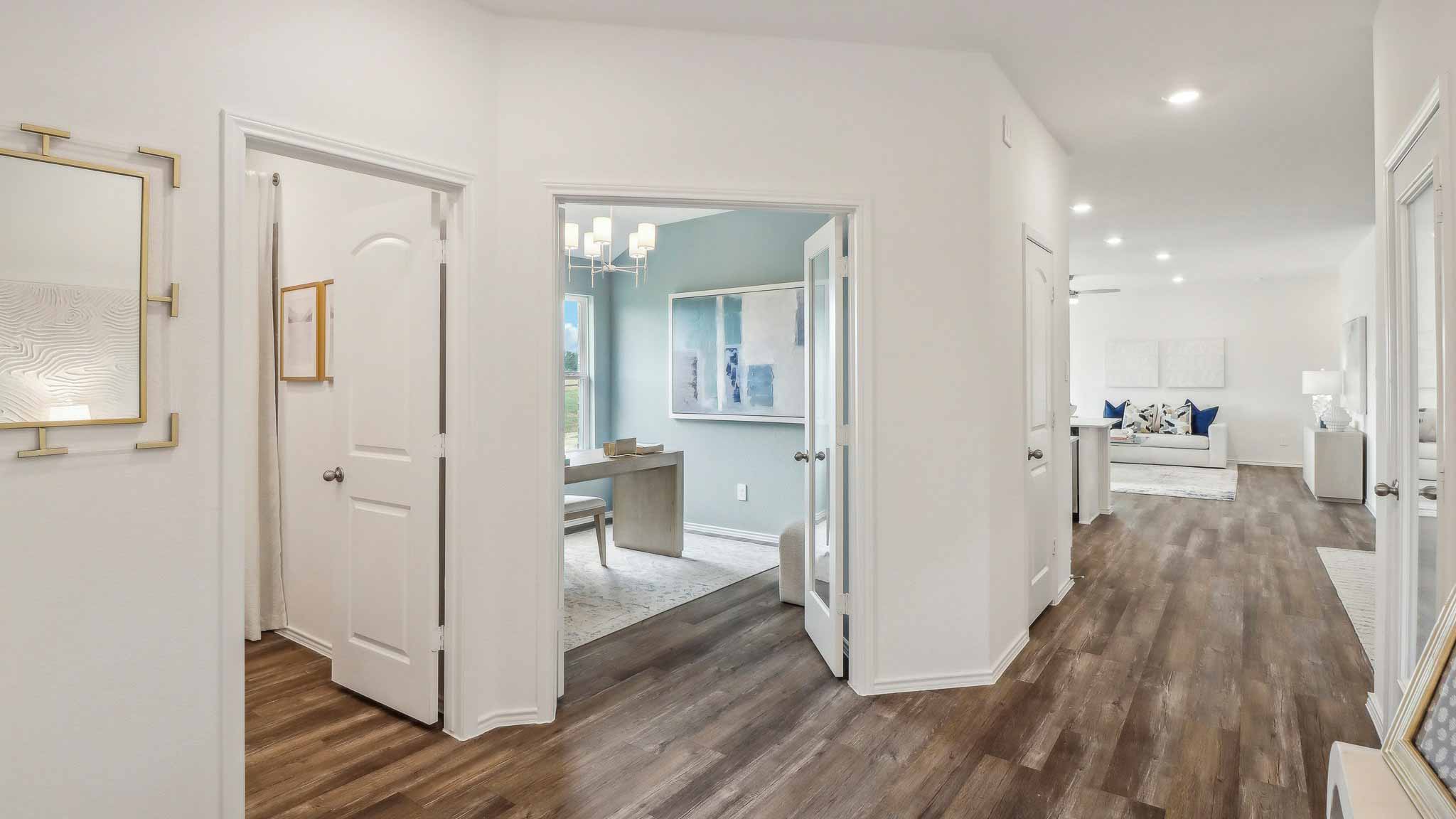 open concept living and dining area with vinyl flooring, large windows, and quartz countertops