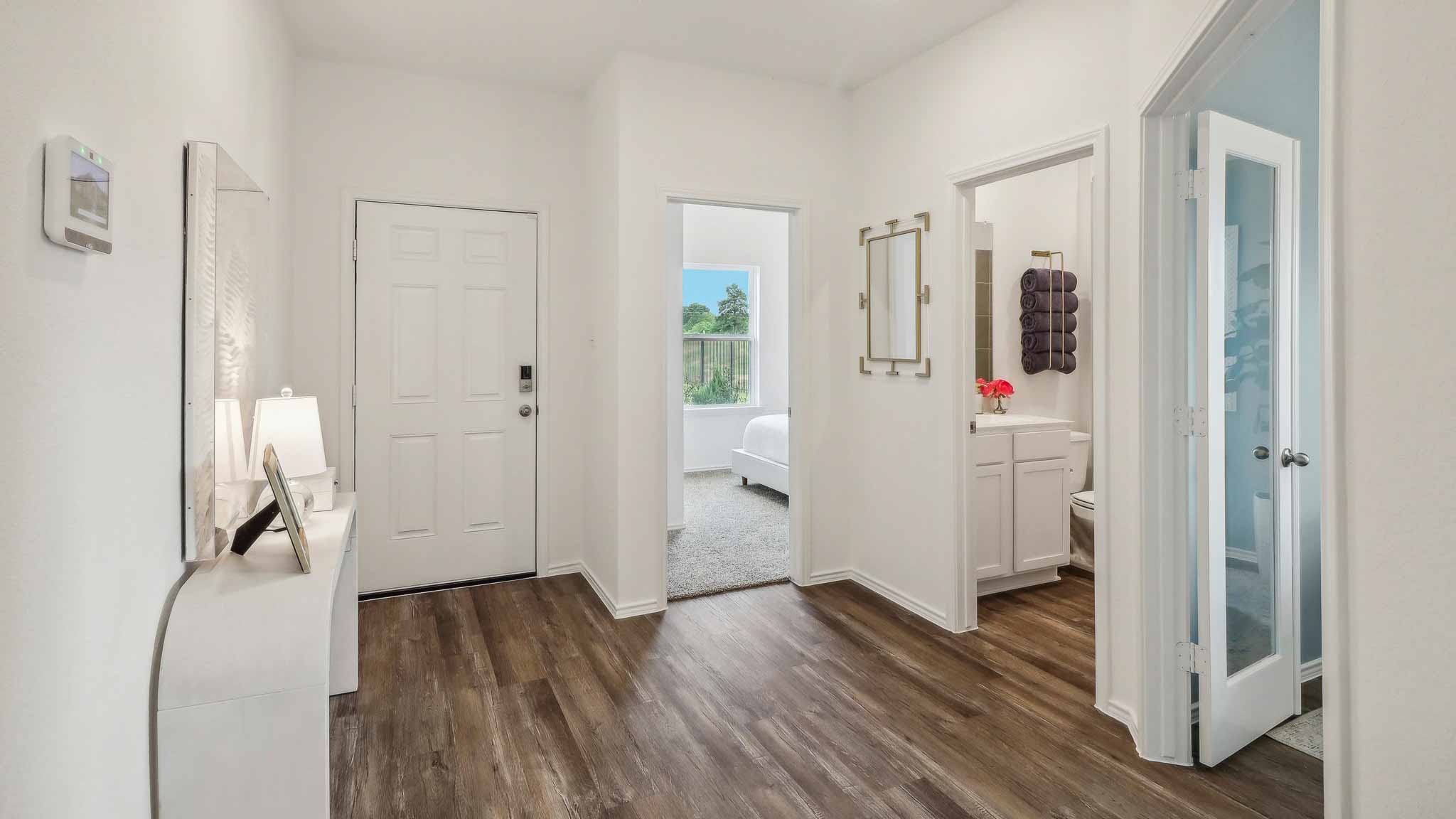 open concept living and dining area with vinyl flooring, large windows, and quartz countertops