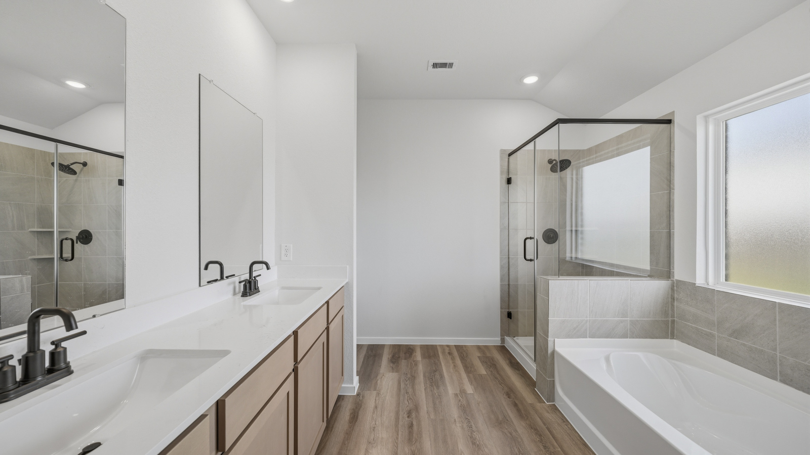 primary bathroom with separate tub and shower