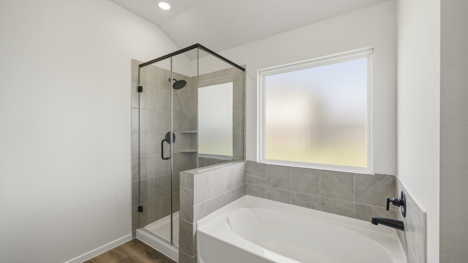 primary bathroom with separate tub and shower