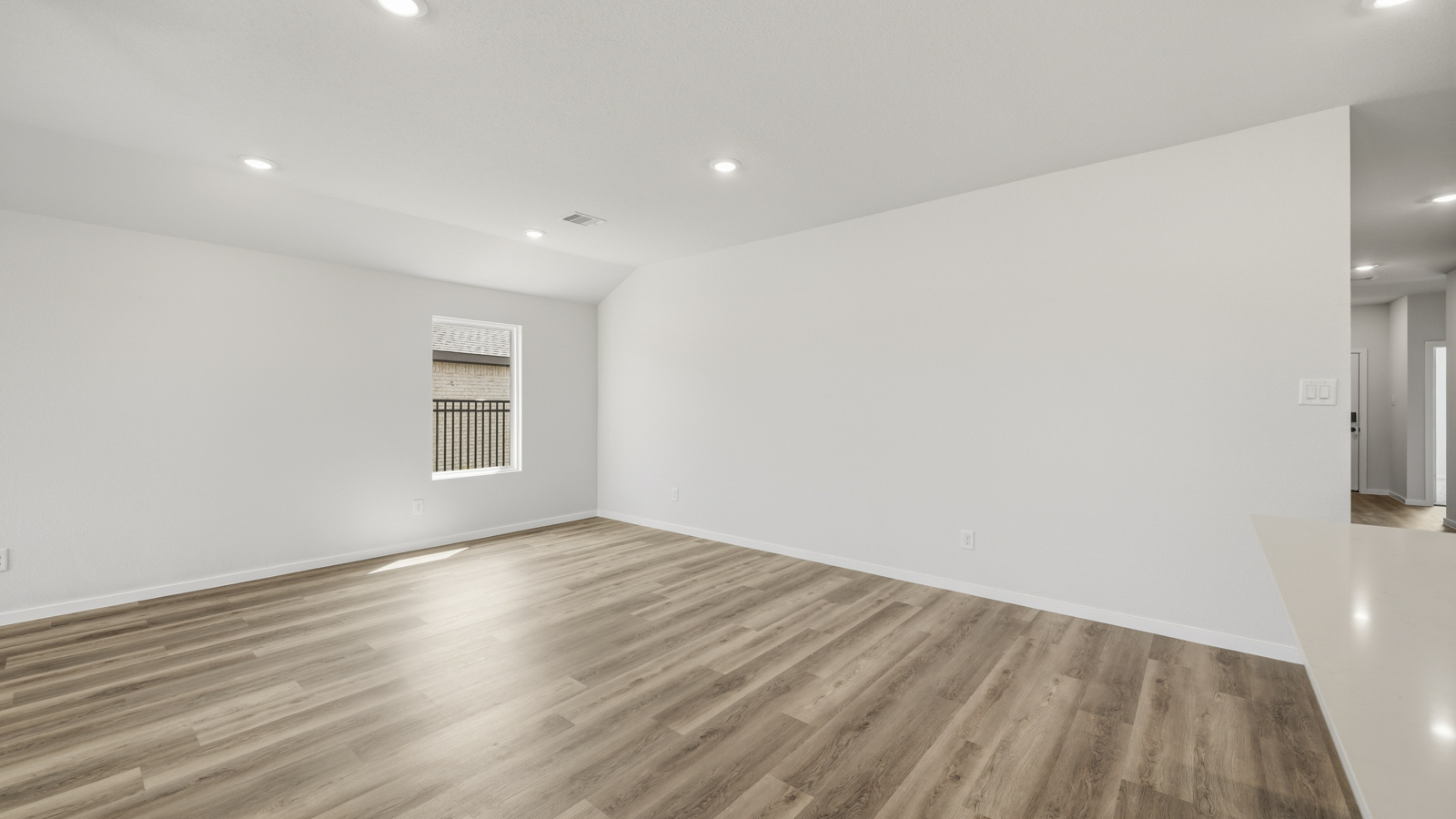 open concept living and dining area with vinyl flooring and large windows