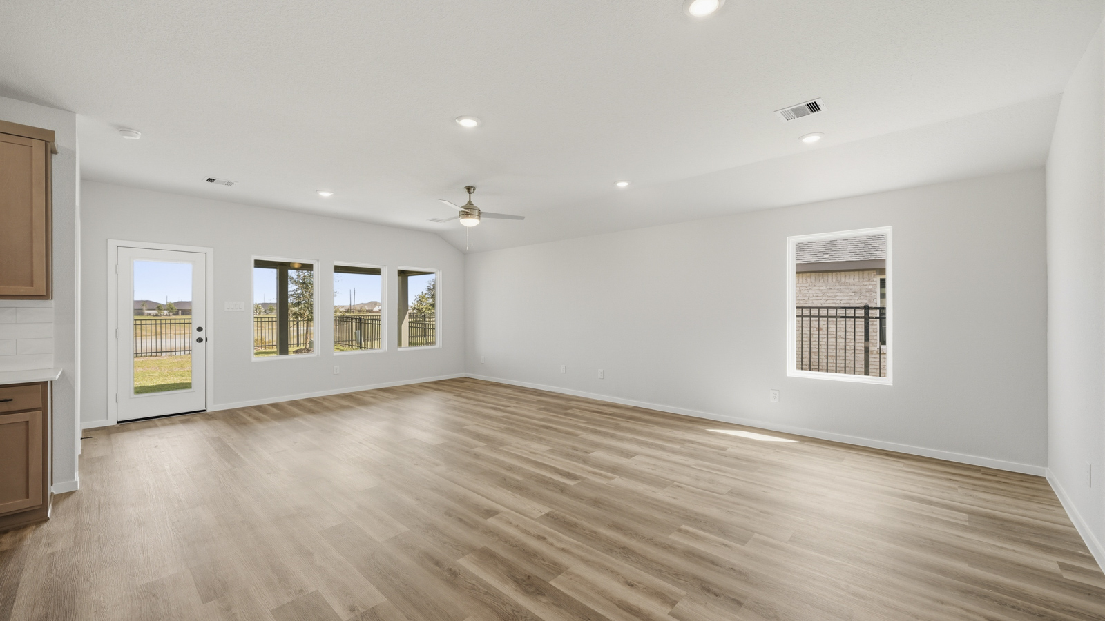 open concept living and dining area with vinyl flooring and large windows
