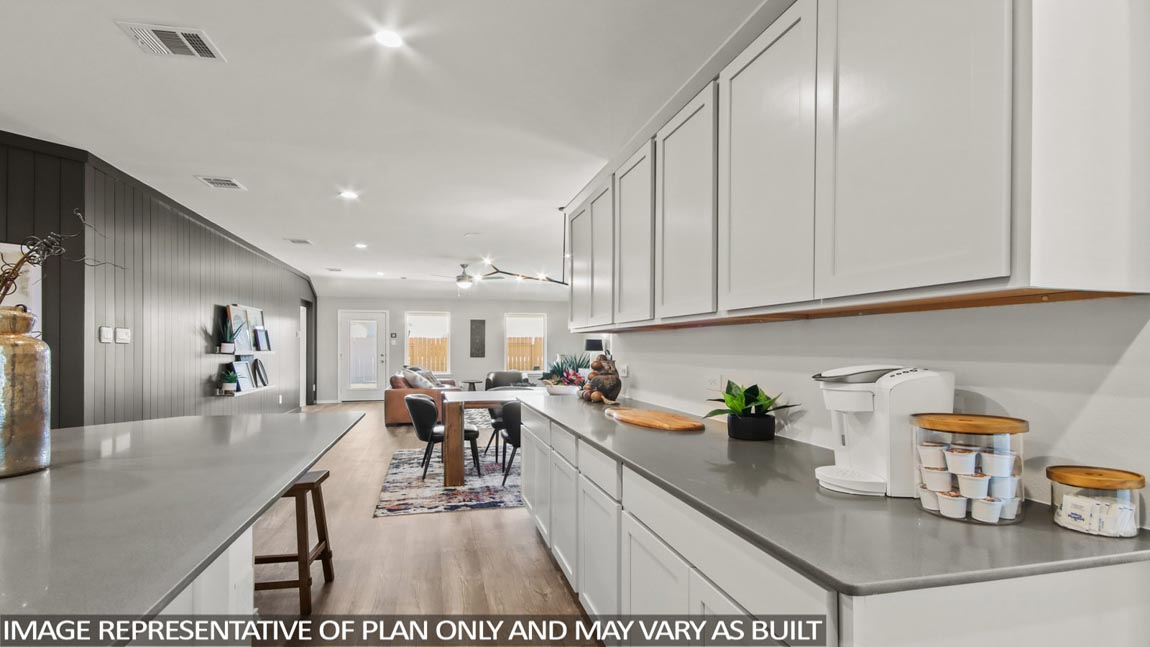 open concept living and dining area with vinyl flooring, large windows, and quartz countertops