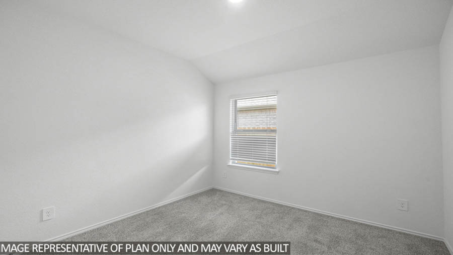 Secondary bedroom with carpet flooring
