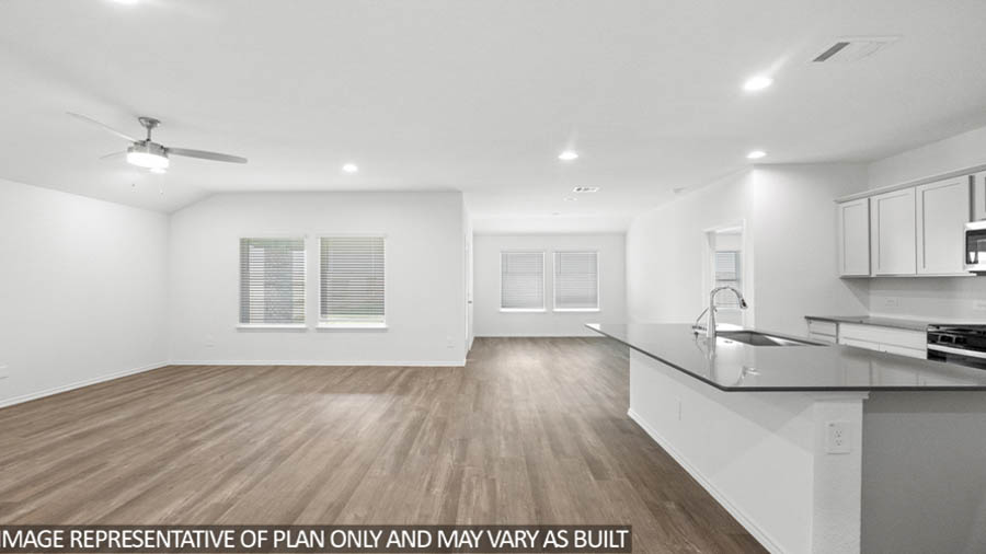 Spacious living area with vinyl flooring