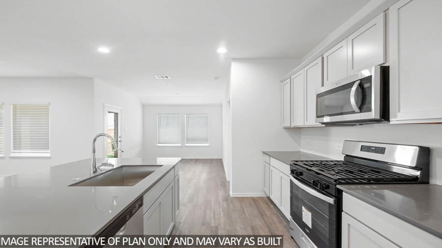 Kitchen with an island and vinyl floor