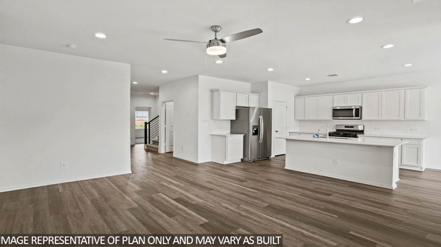 open concept living and dining area with vinyl flooring, quartz countertops, and large windows