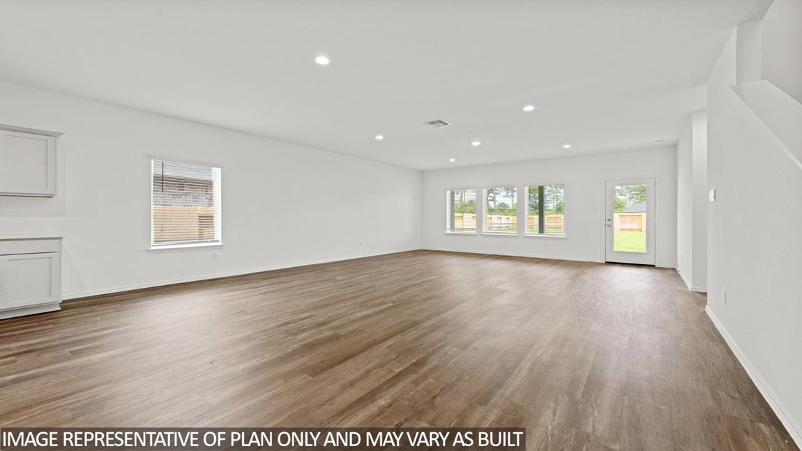 open concept living and dining area with vinyl flooring, quartz countertopd, and large windows