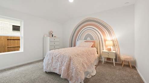 Secondary bedroom with windows, white walls, and light carpet.