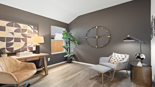 Study with windows, white walls, and vinyl wood flooring.