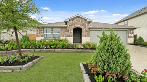 Single story model home with brick in Sunterra.