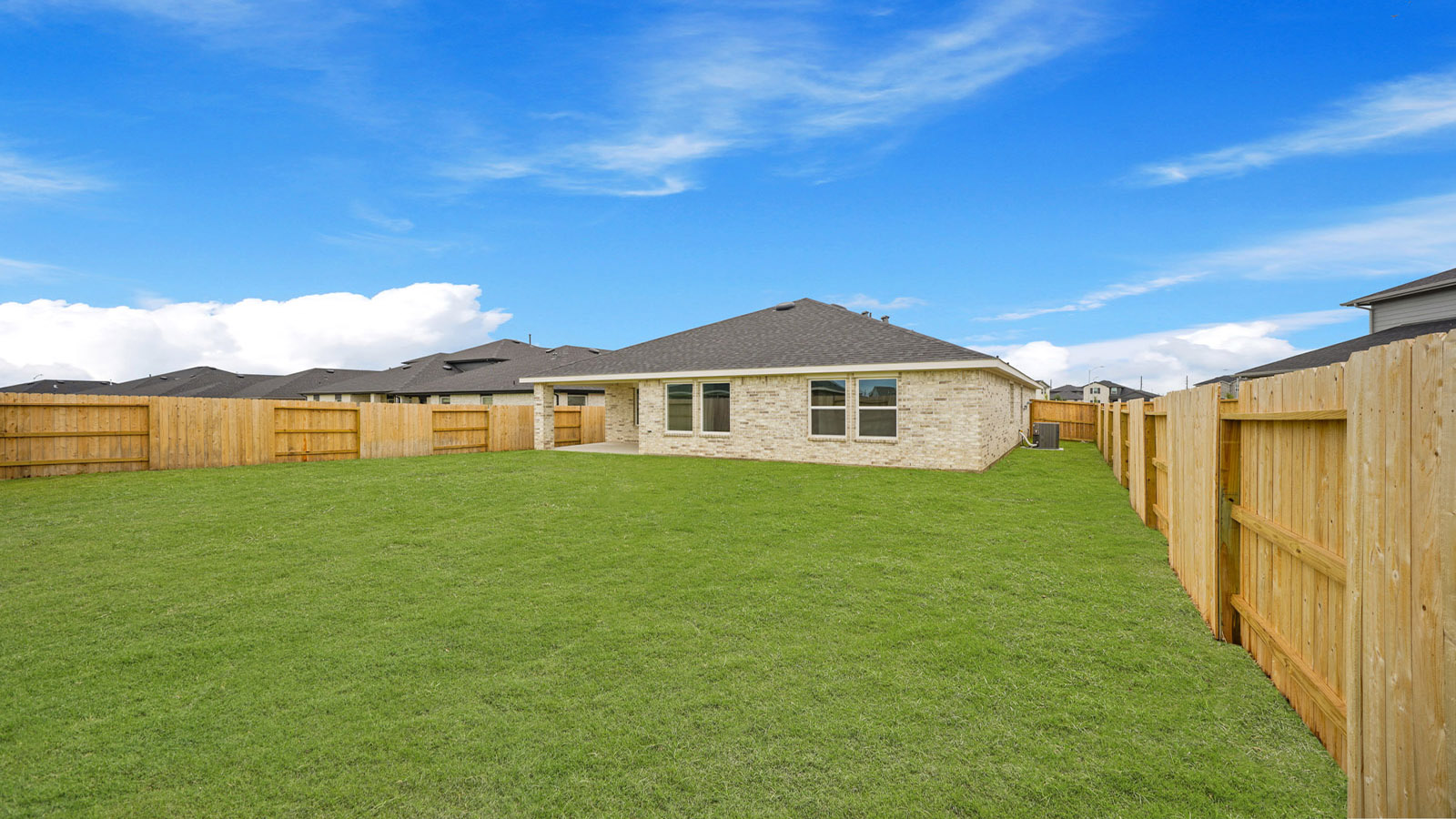 Rear concrete patio connected to dining - family room offering outdoor access in this New Construction Home