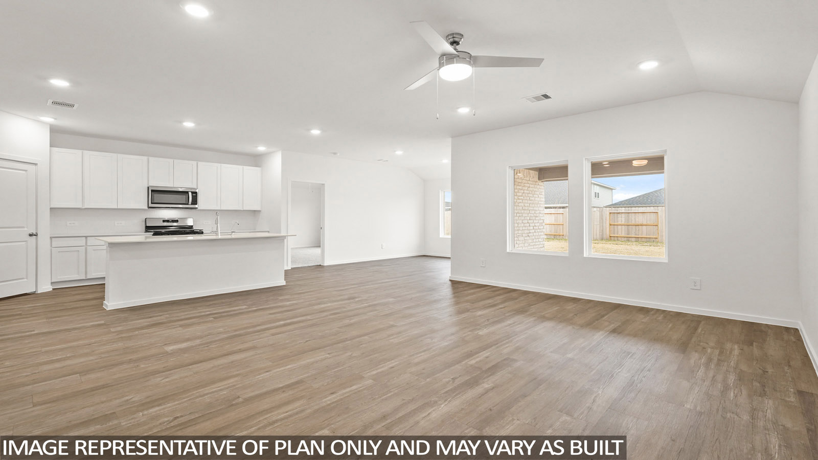 open concept living room with vinyl flooring, quartz countertops, and large windows