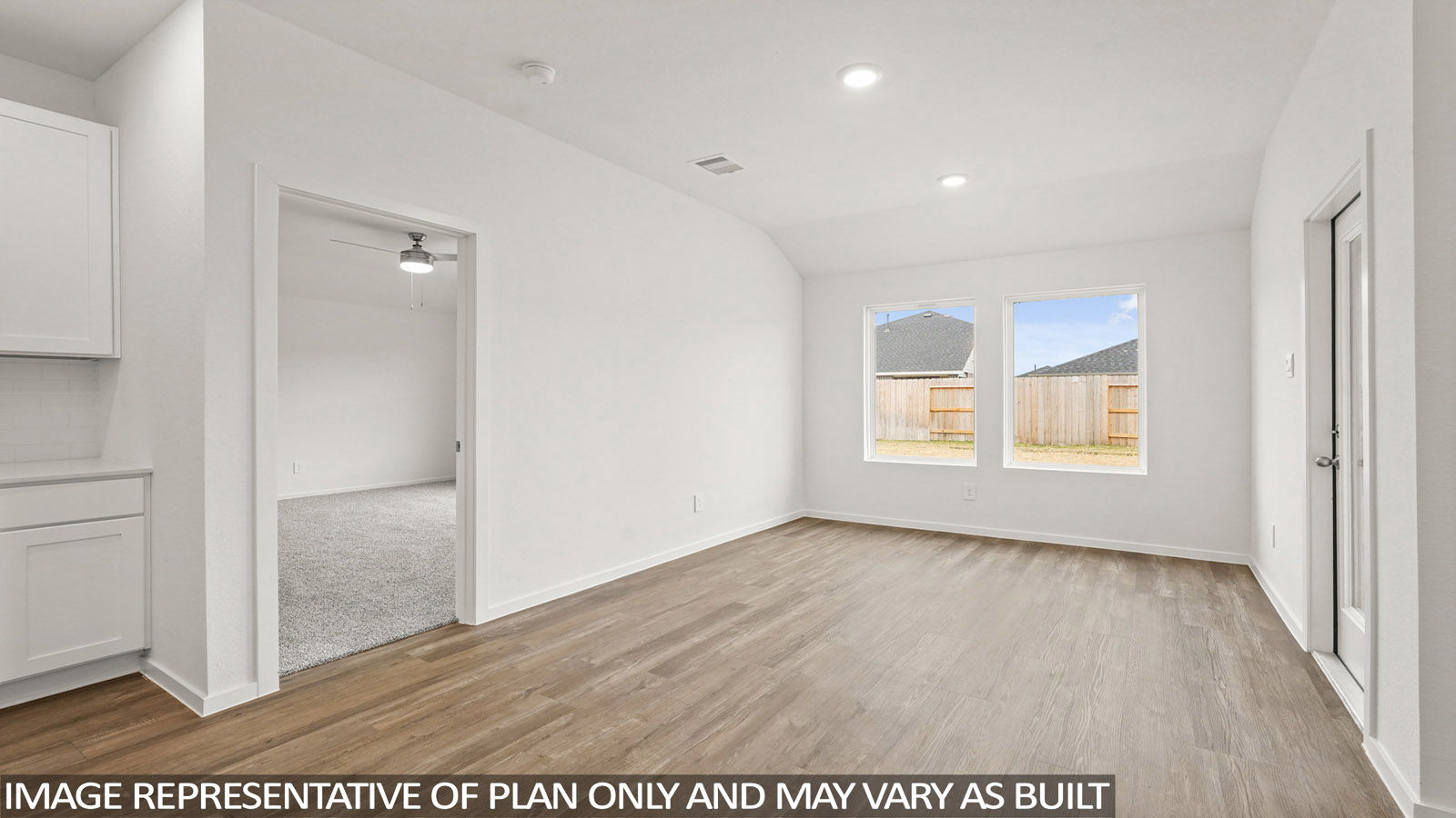open concept living room with vinyl flooring, quartz countertops, and large windows