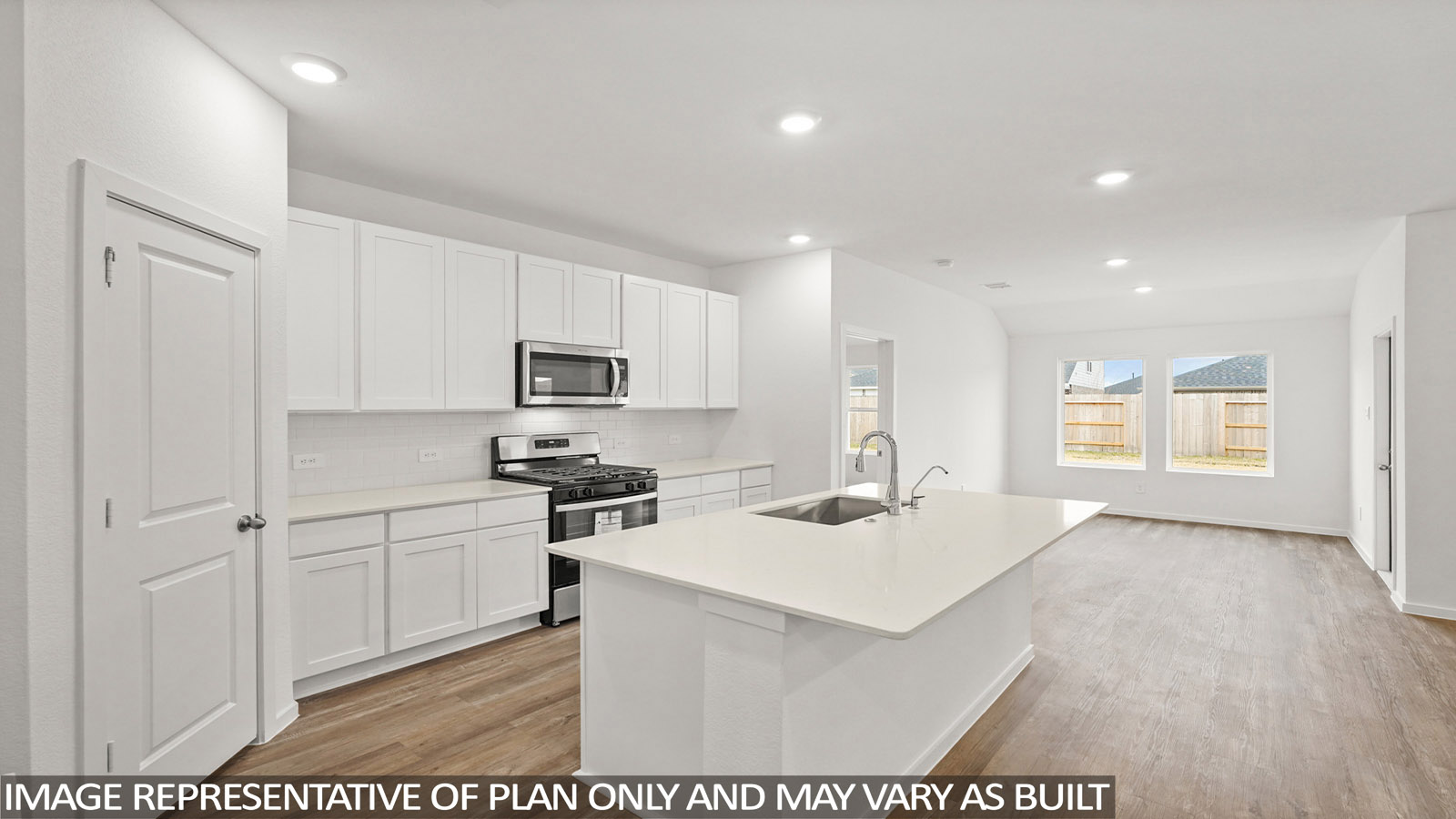 open concept living room with vinyl flooring, quartz countertops, and large windows