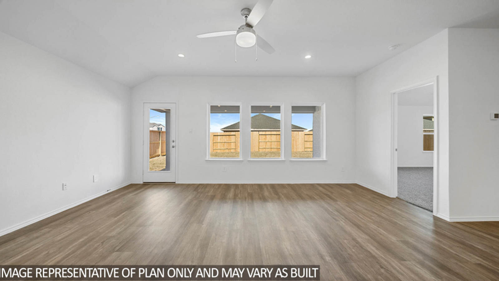 open cncept living and dining area with vinyl flooring, large windows, and quartz countertops in Katy, TX