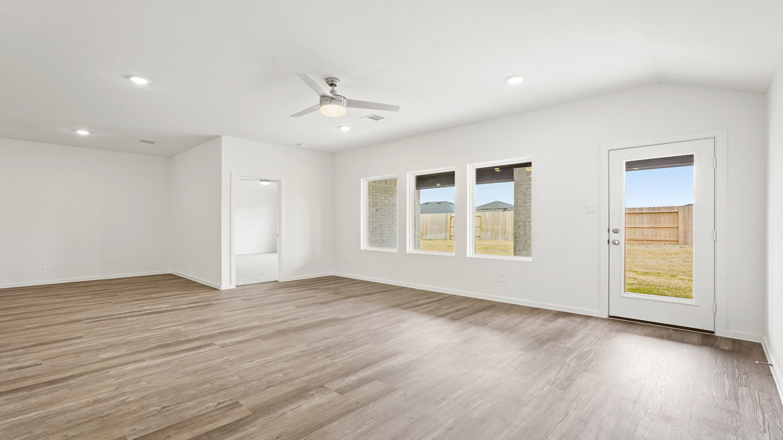 open concept living and dining area with vinyl flooring