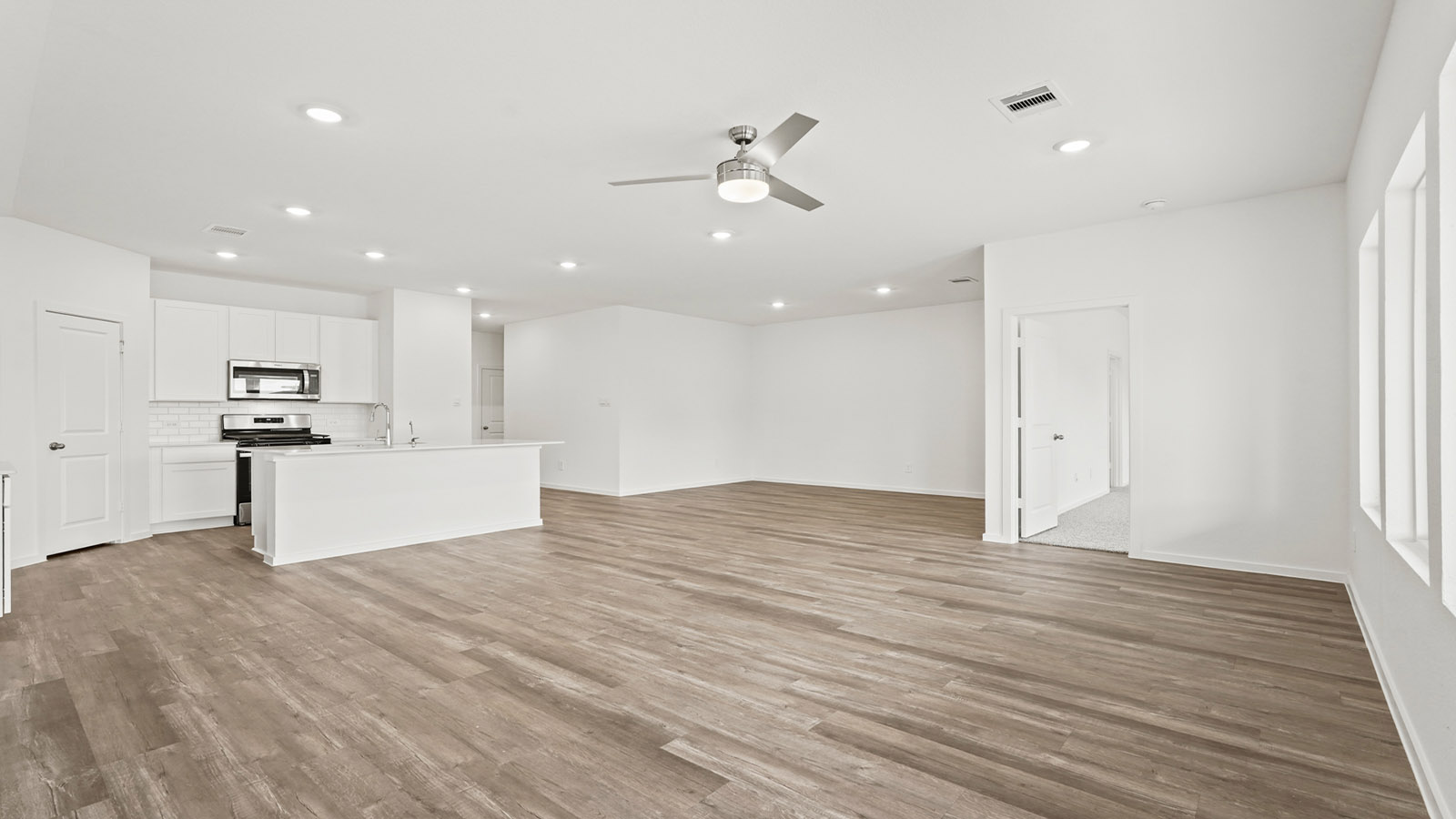 open concept living and dining area with vinyl flooring