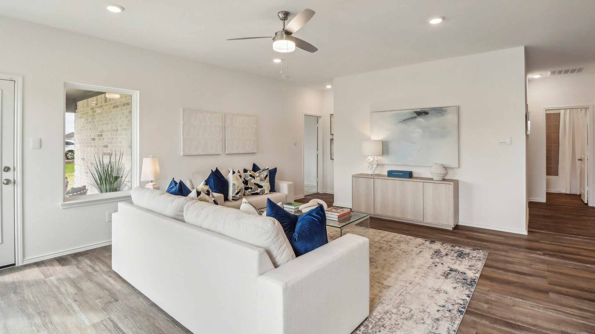 open concept living and dining area with vinyl flooring, quartz counertops, and large widows