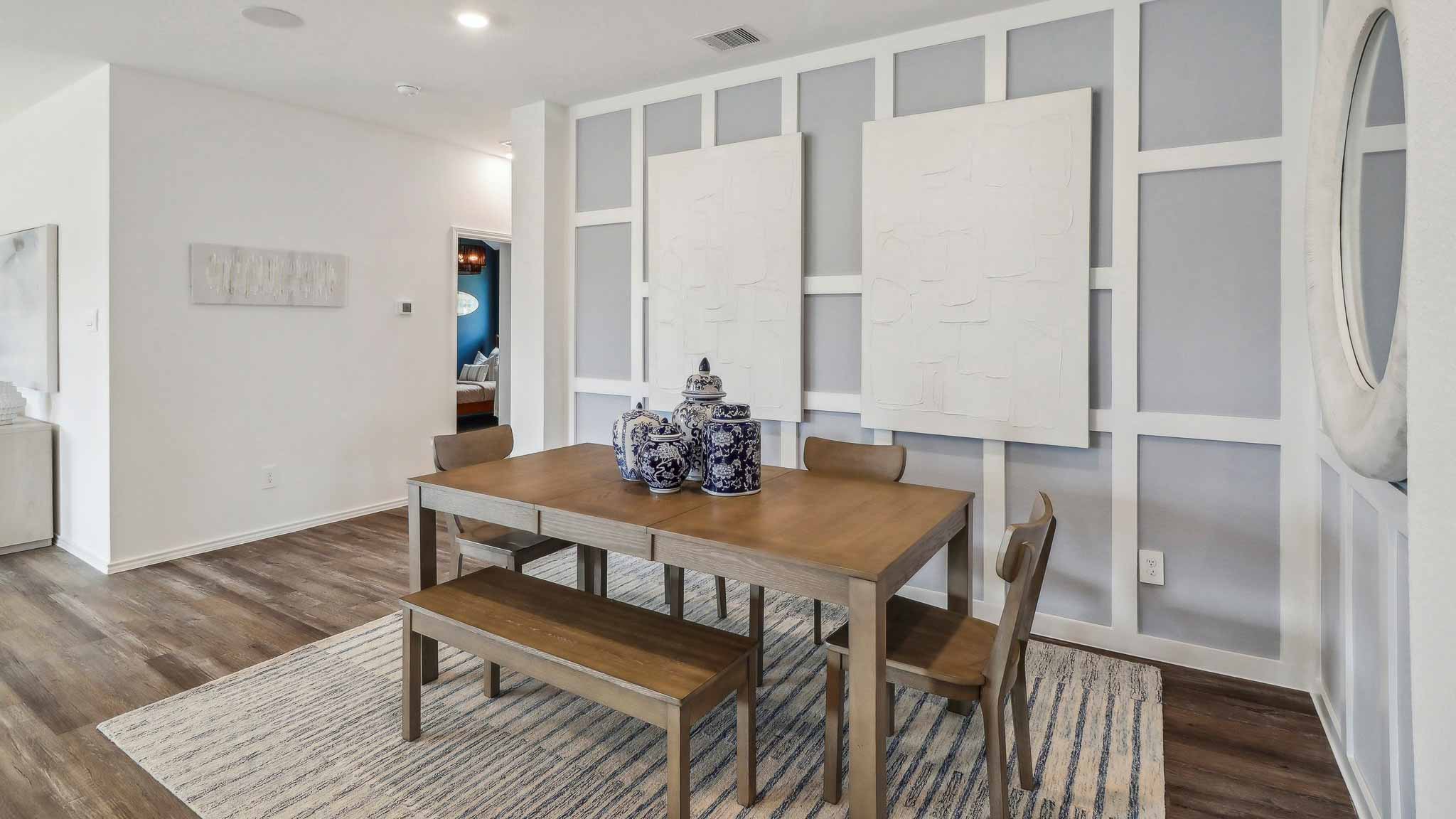 open concept living and dining area with vinyl flooring, quartz counertops, and large widows