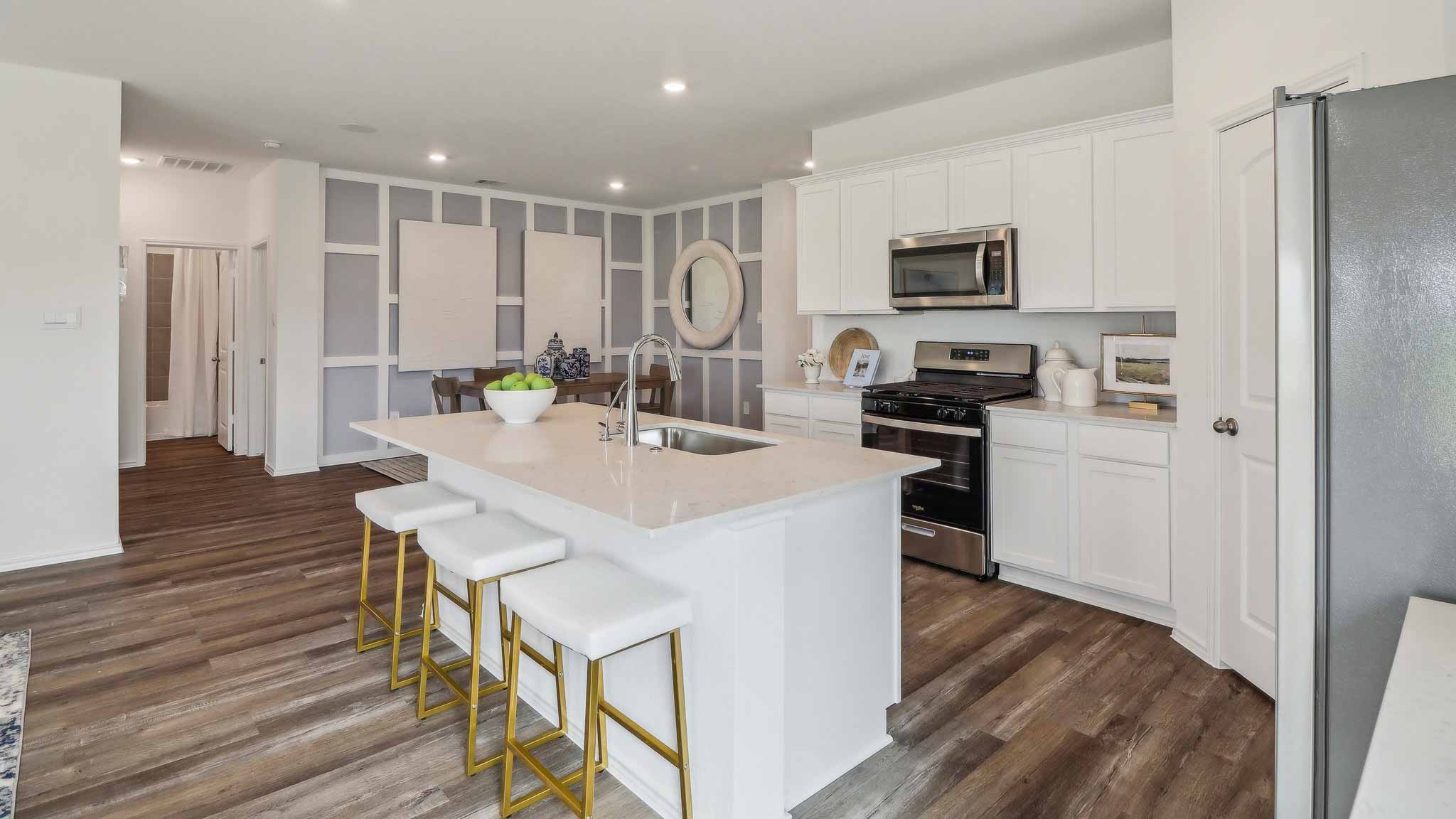 open concept living and dining area with vinyl flooring, quartz counertops, and large widows