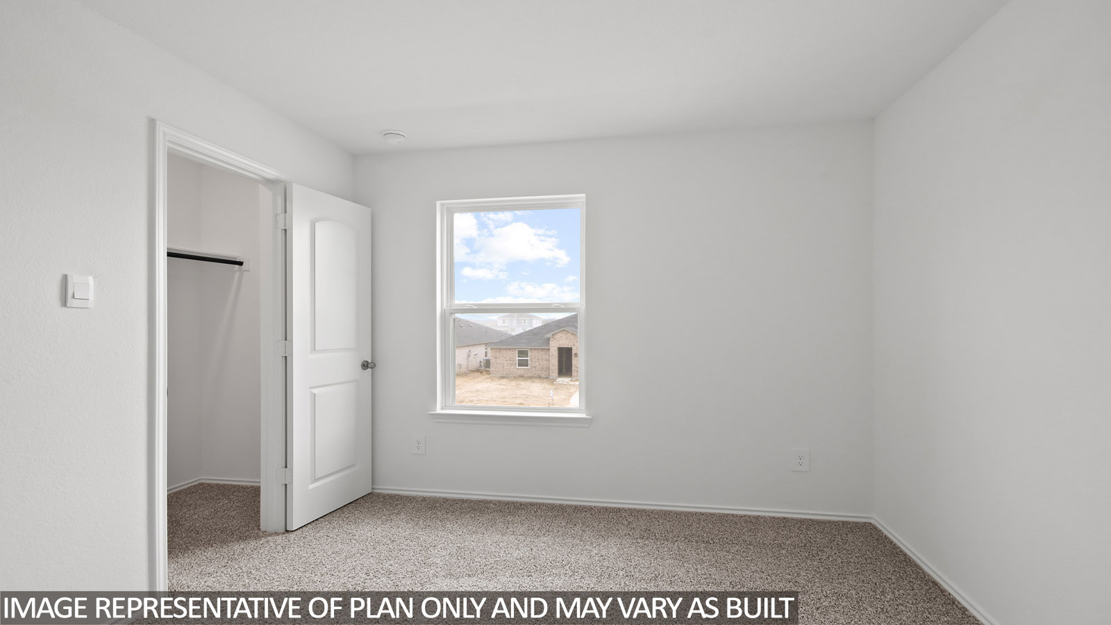 Secondary bedroom with carpet flooring