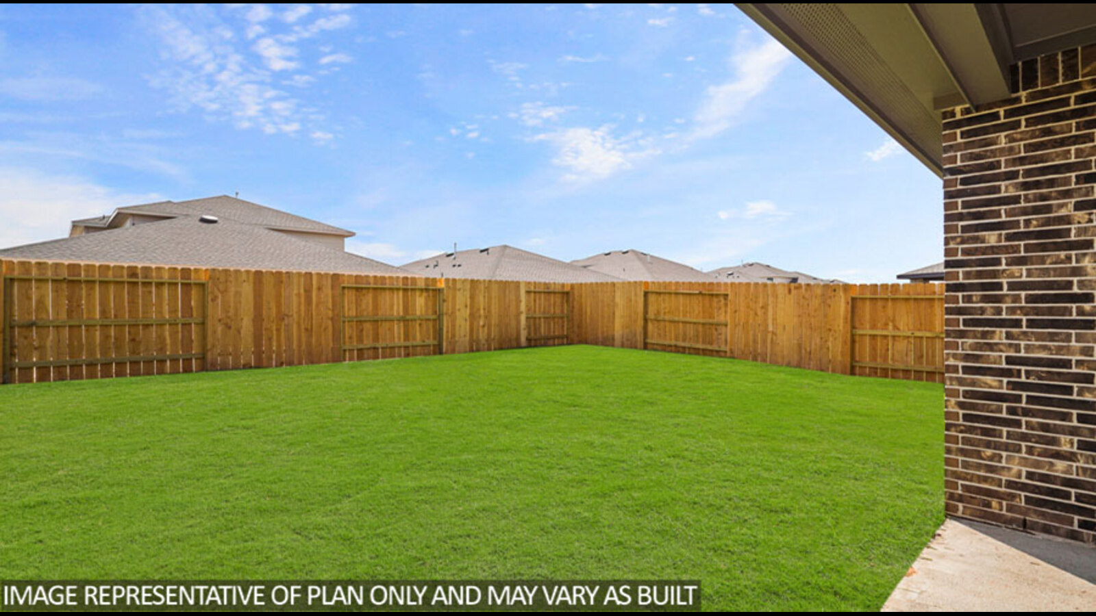 Landscaped backyard with a covered patio.